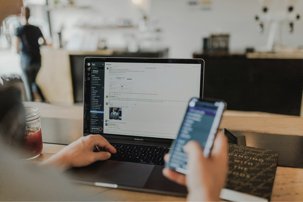 Person working on a laptop and phone